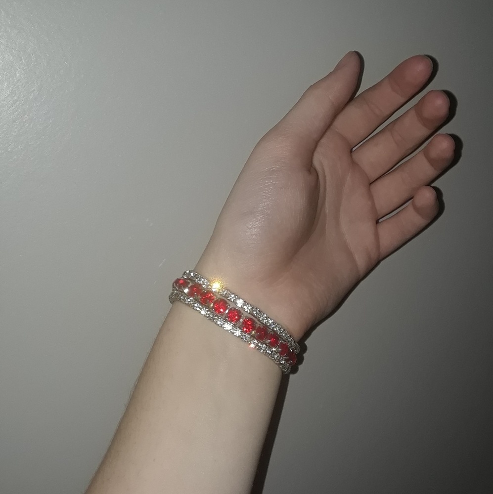 Two diamond and one ruby bracelets